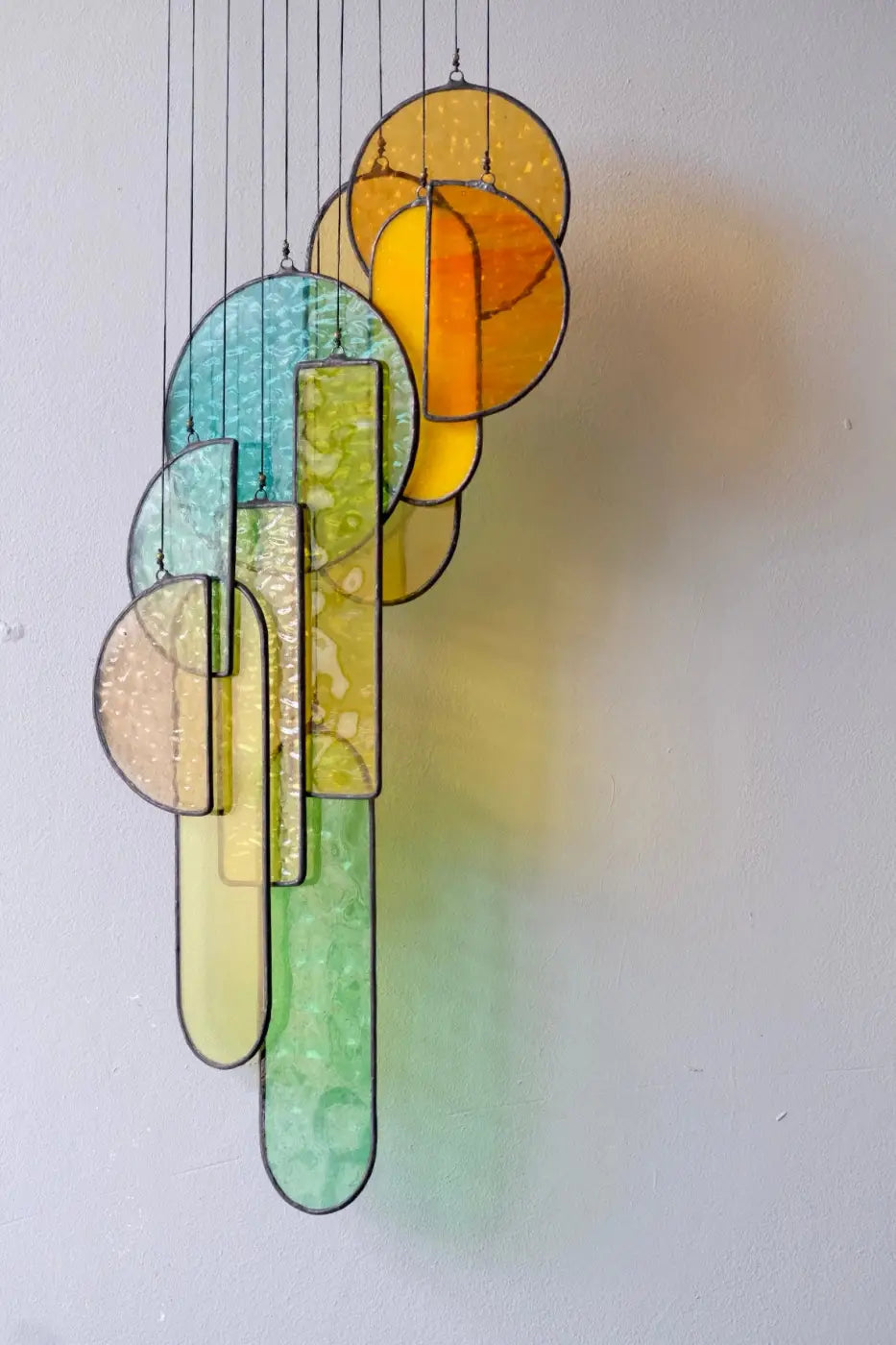 Autumn 2 stained glass hanging sculpture featuring a vibrant multi-colored chandelier with circular and rectangular panels
