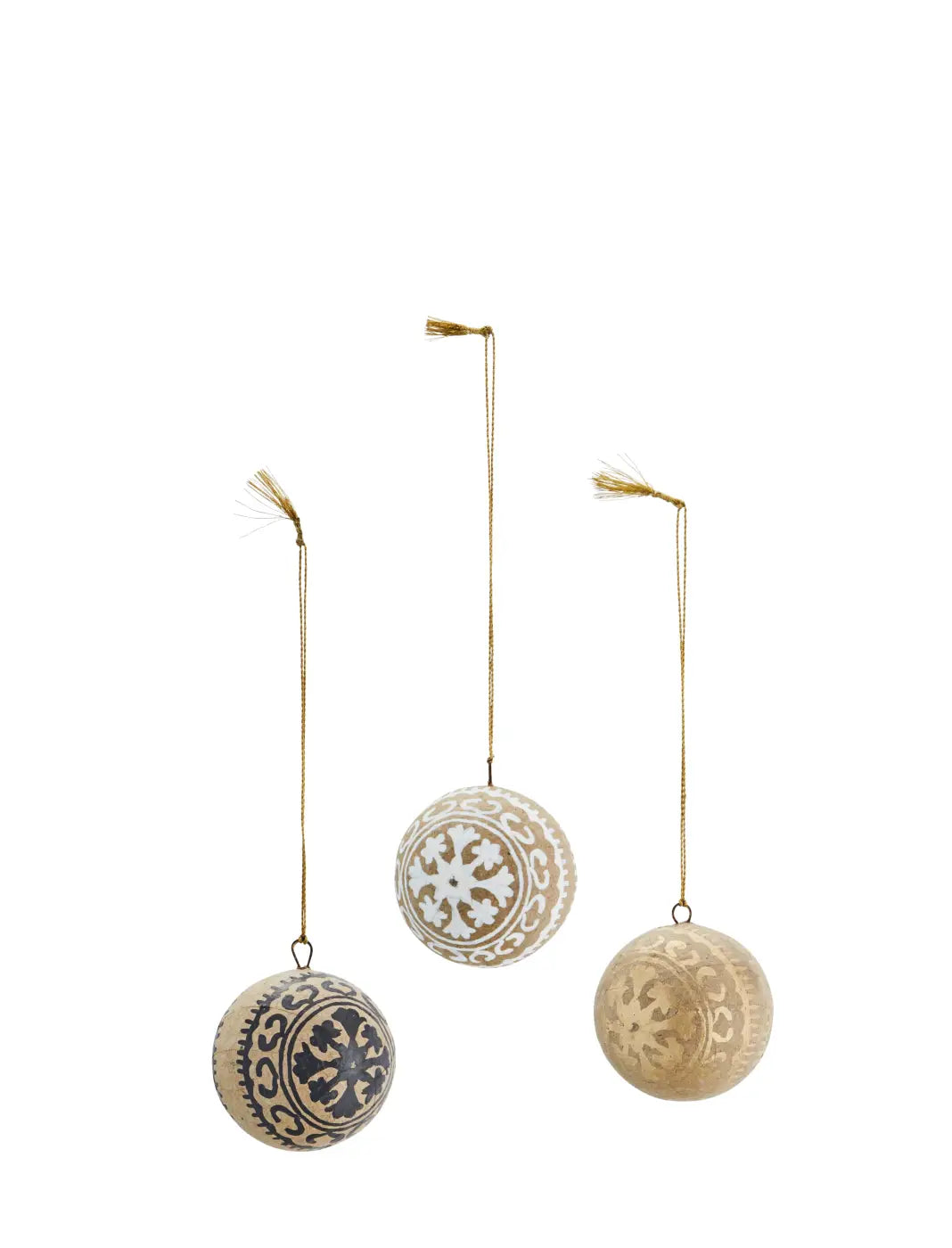 Three hand painted paper mache baubles with intricate white and dark blue patterns hanging from gold strings