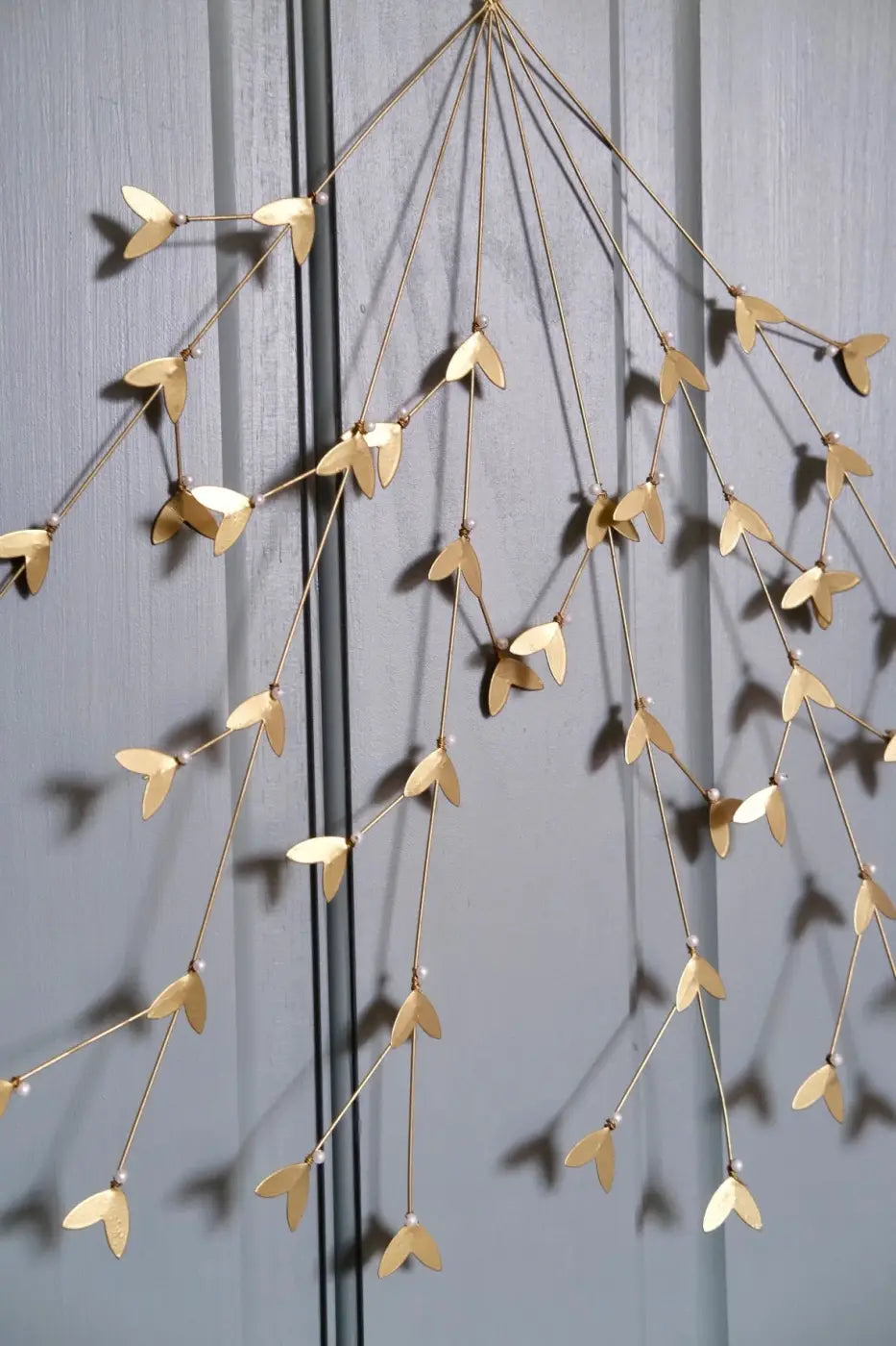 Handmade large iron mistletoe wreath in gold-toned metal with delicate leaf ornaments and tiny pearl-like beads