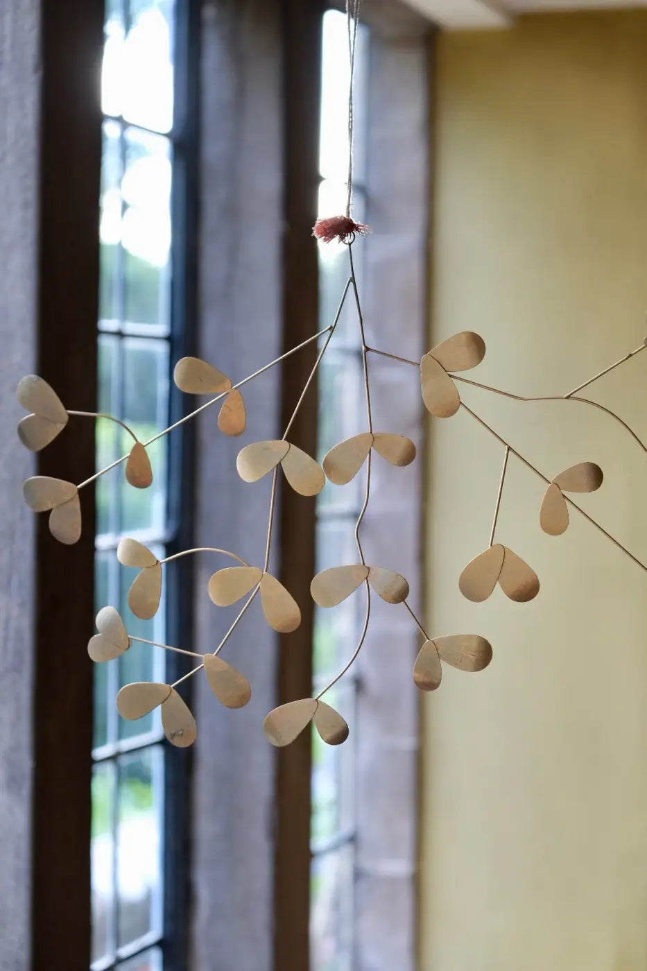 Handmade iron mistletoe delicate beige metal branch ornament with heart shaped leaves hanging from string