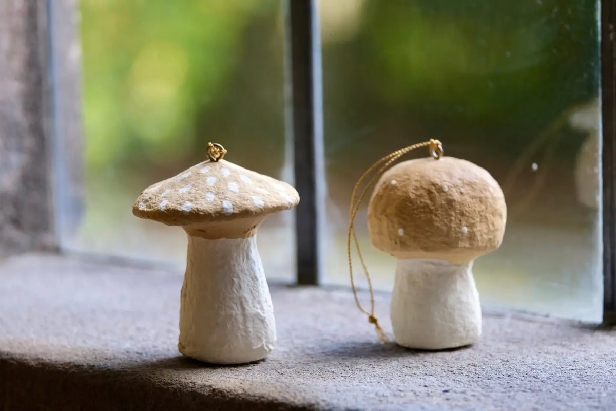 Handmade toadstool decorations featuring handcrafted paper mushroom ornaments with speckled caps and gold hanging loops