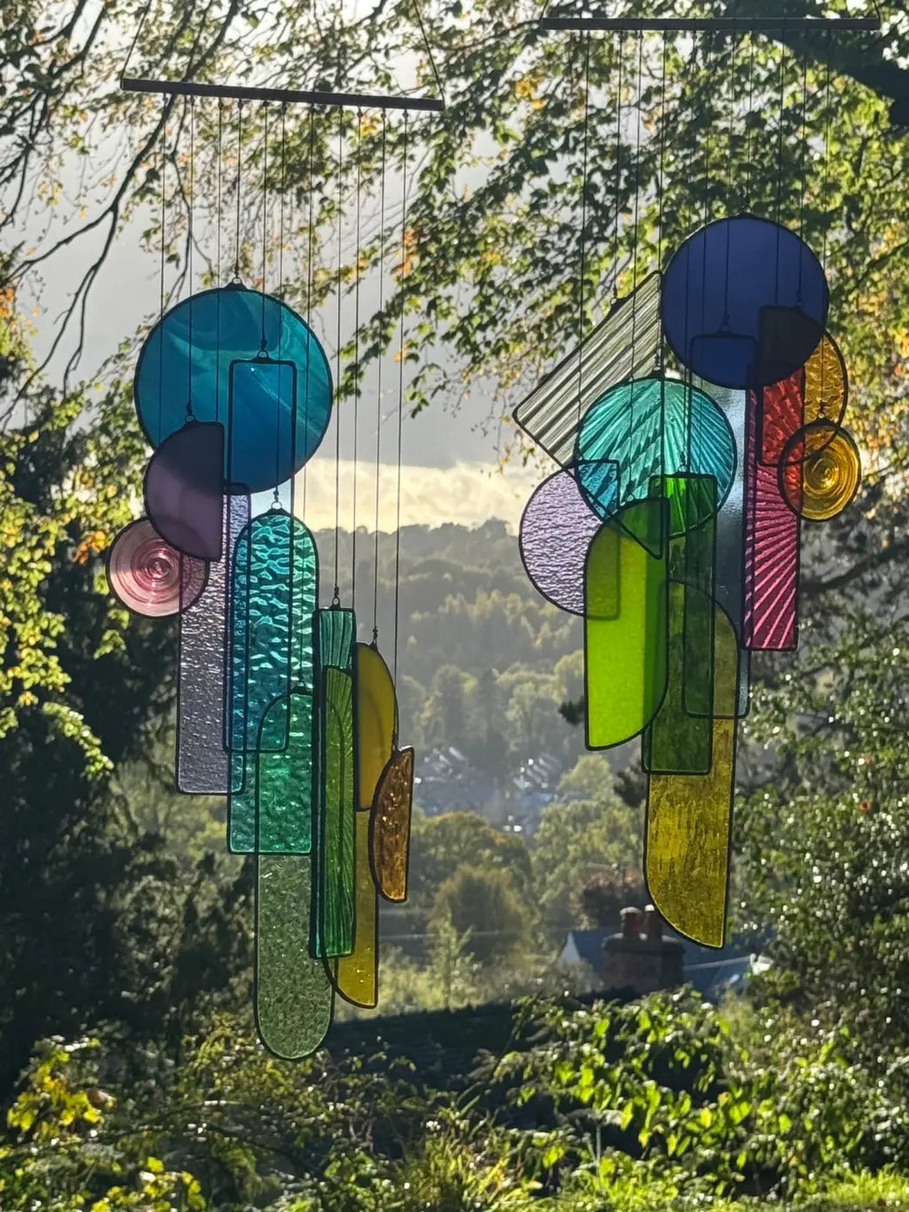 Vibrant multicolored stained glass wind chime with geometric and organic shapes in Lawrence 1 sun catcher artwork