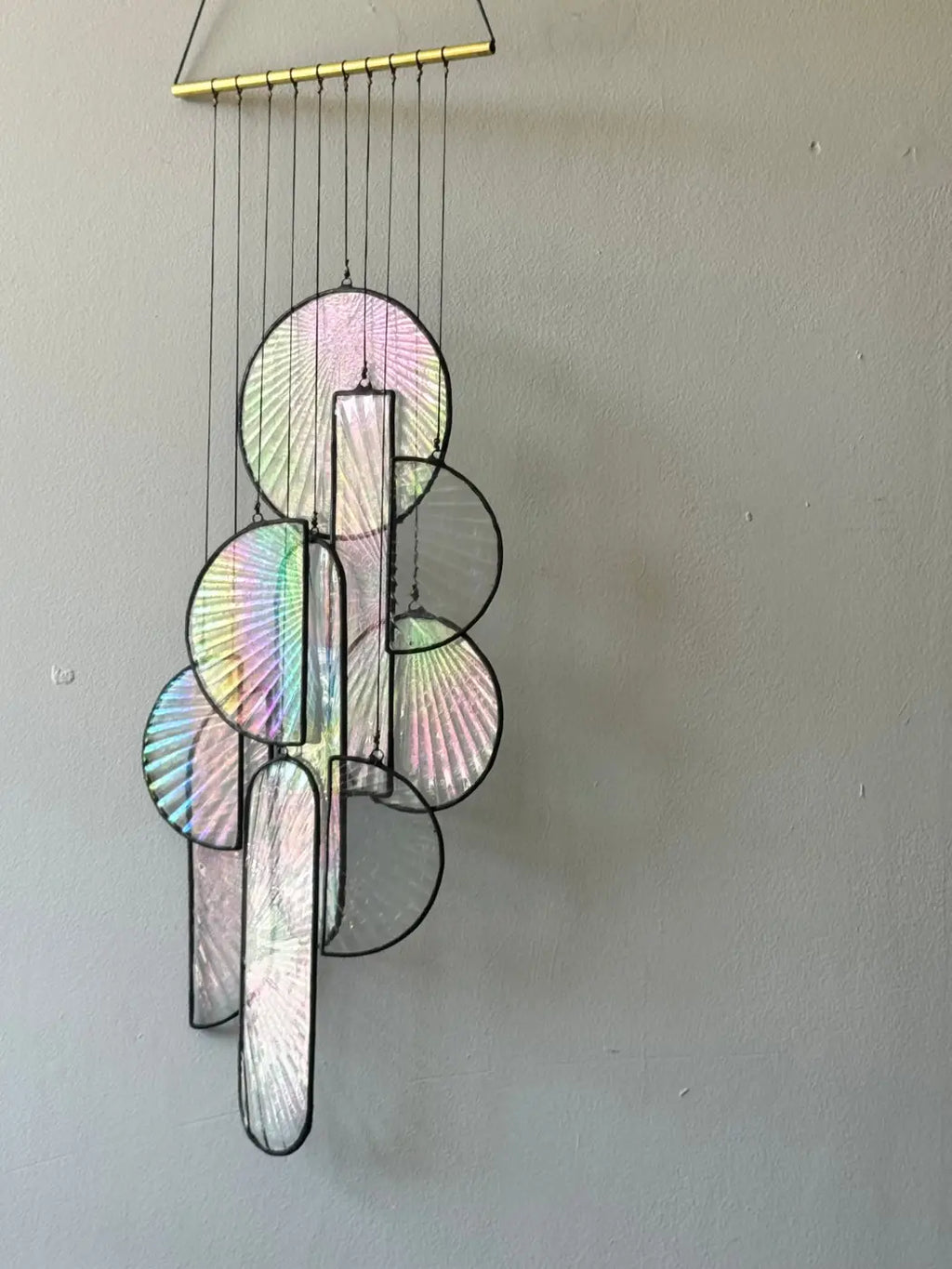 Les Sylphides stained glass art delicate iridescent wind chime with circular and rectangular panels on gold metal bar