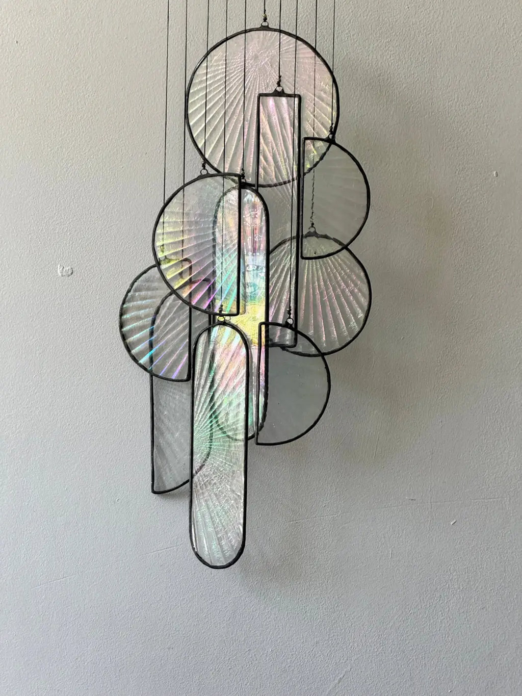 Les sylphides stained glass art features modern hanging black metal frames with iridescent fan-like circular and rectangular panels