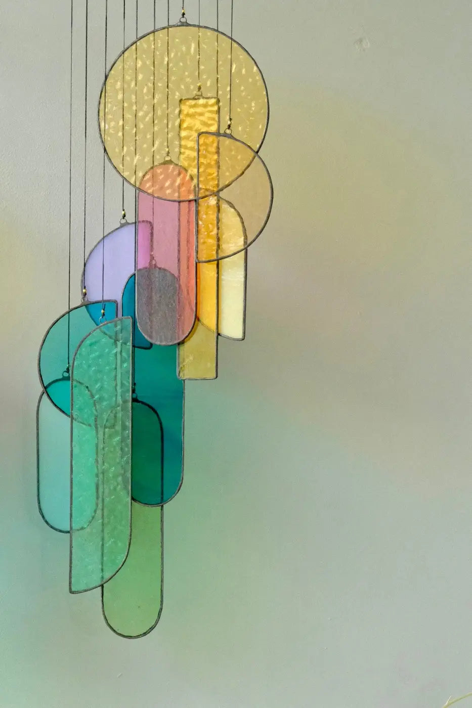 Rainbow stained glass art colorful chandelier with geometric shapes in yellow pink teal and green hues