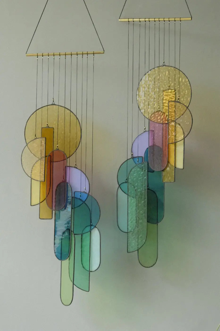 Rainbow stained glass art colorful geometric wind chime with translucent yellow green blue purple and amber panels