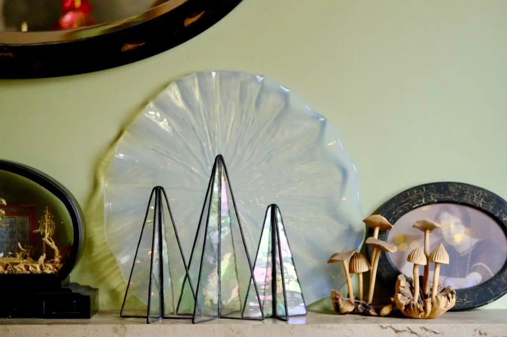 Sapin trees set of three iridescent geometric glass triangle sculptures with black metal frames and translucent panels