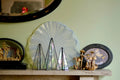 A translucent iridescent glass fan with a delicate radiating pattern from sapin trees set of three iridescent