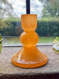 Small bobbin candle holder vibrant orange glass with sleek modern three rounded tier design