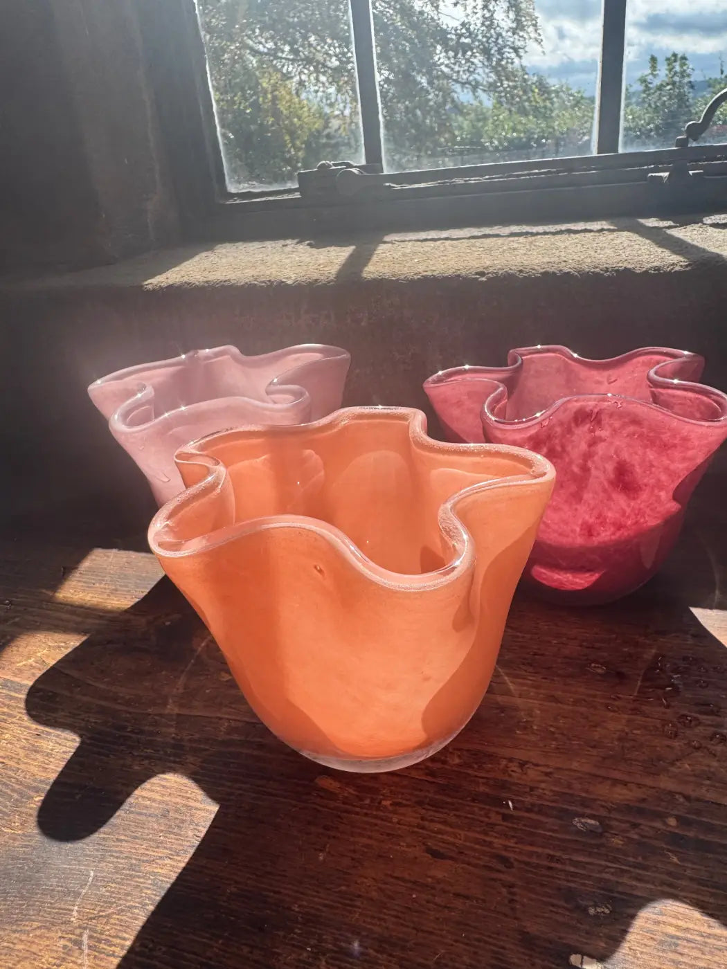 Set of three small ruffle vases hand-blown glass in soft pink coral orange and deep red with wavy organic rims