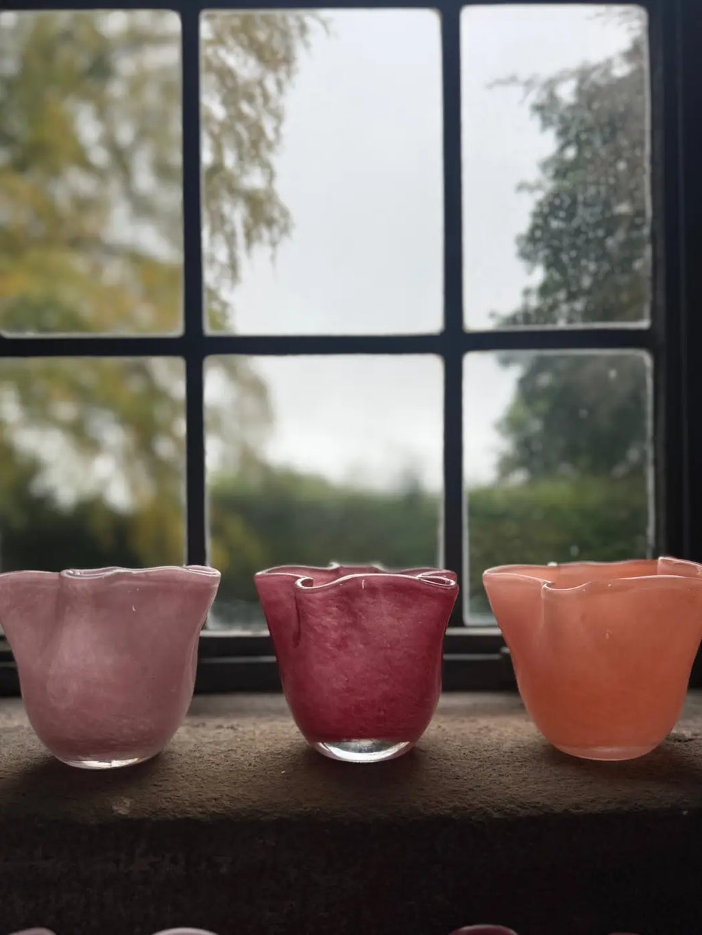 Small ruffle vase set of three hand-blown glass cups with ruffled petal rims in pink magenta and peach hues