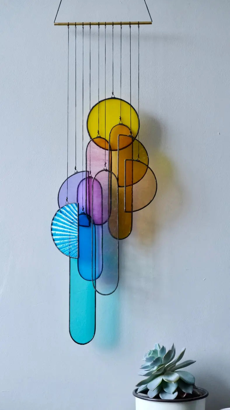 Spectrum 2 stained glass sun catcher with colorful yellow purple blue and orange geometric shapes hanging from wood top