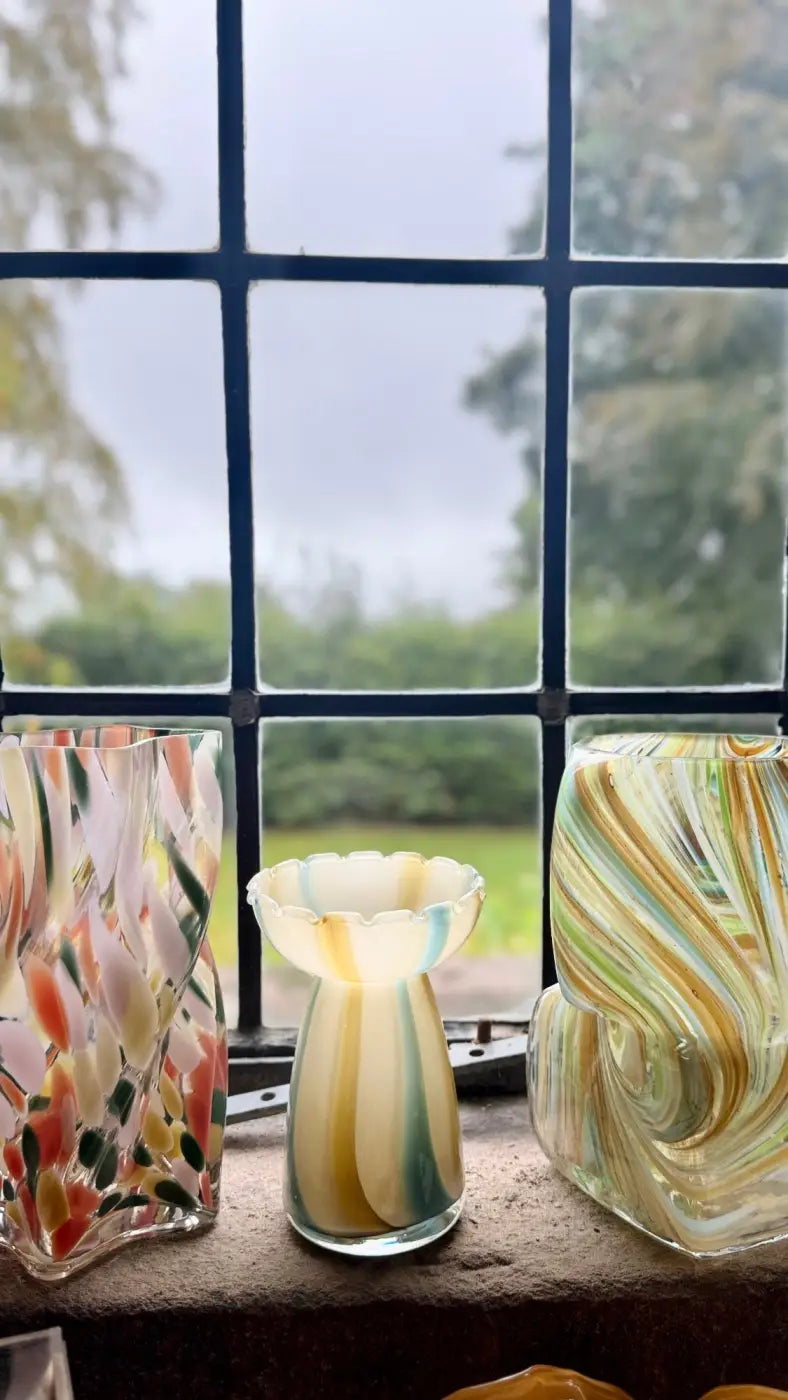 Striped glass vase translucent hand-blown with flared rim and swirling cream green and blue patterns