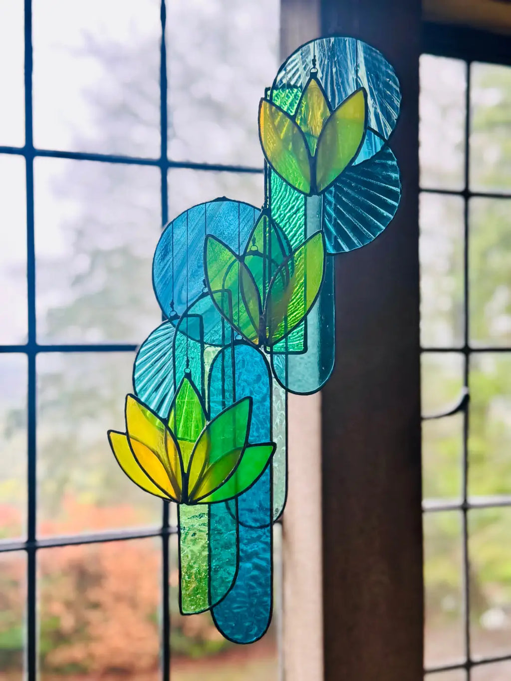 Yellow lotus stained glass hanging art featuring vibrant stylized tulips in yellow green and blue with textured design